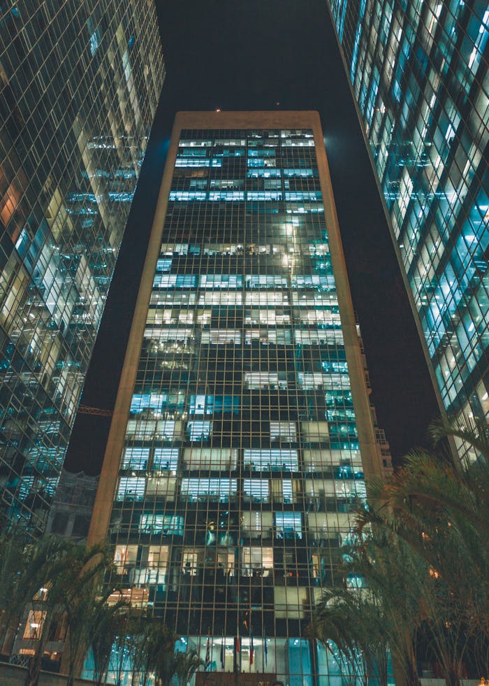 pexels-photo-2100673 View of towering skyscrapers at night with illuminated windows in an urban setting.